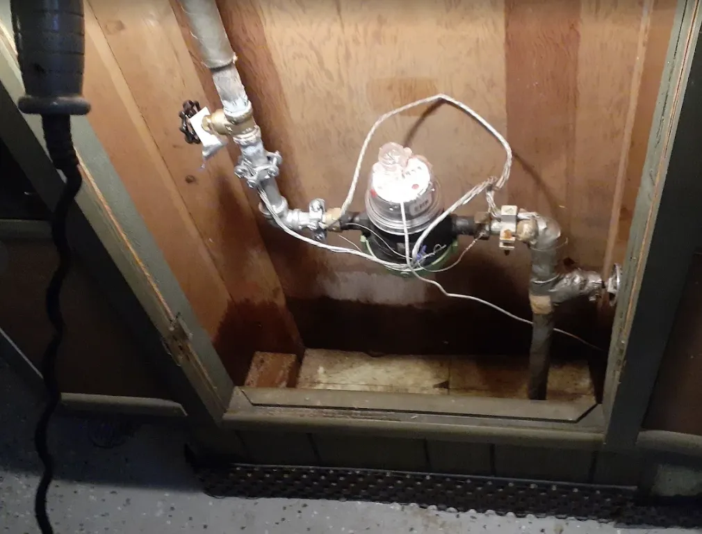 Water meter and inline shutoff valve inside a wood service cabinet
