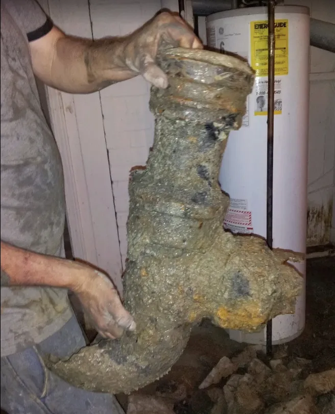 Corroded cast iron drain fitting cut out and replaced