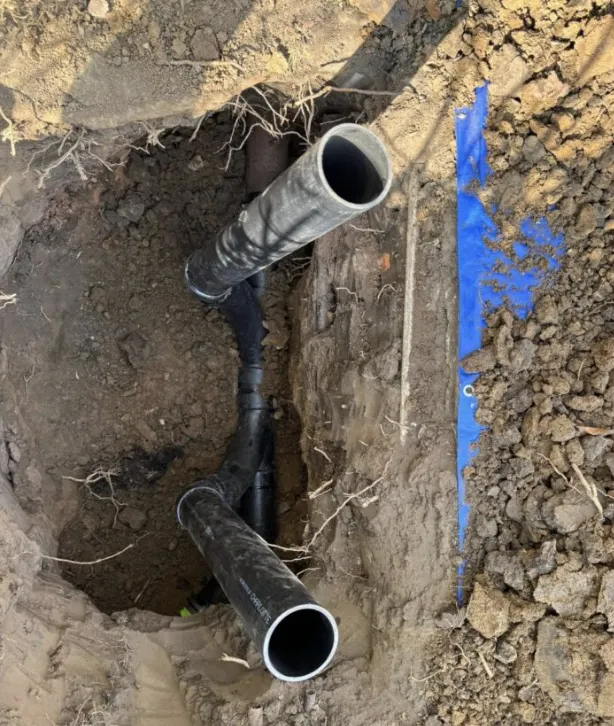 New sewer line with two cleanout risers added so the line can be cleared later